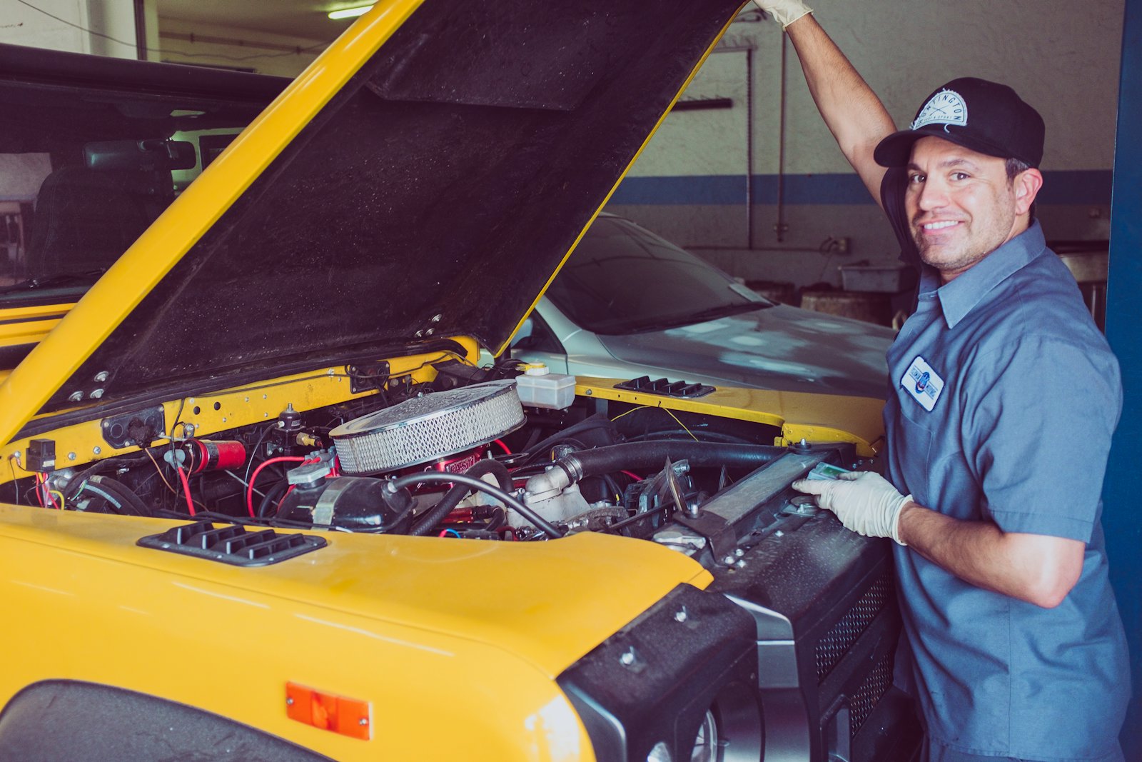 Technician servicing a vehicle engine